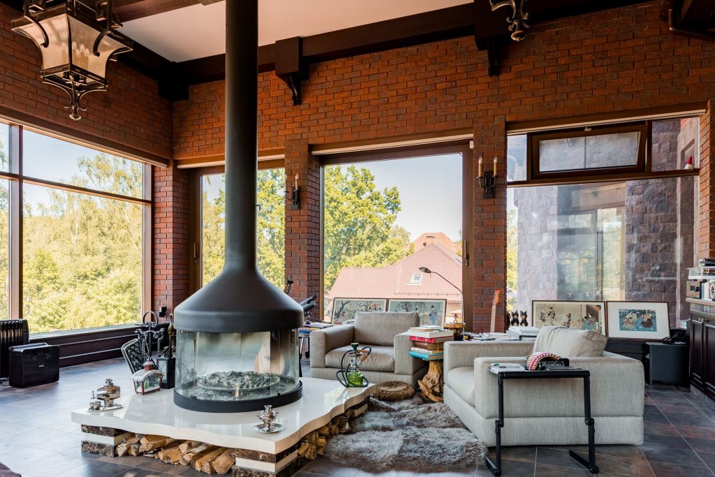 Bright living room with a modern fireplace and armchairs