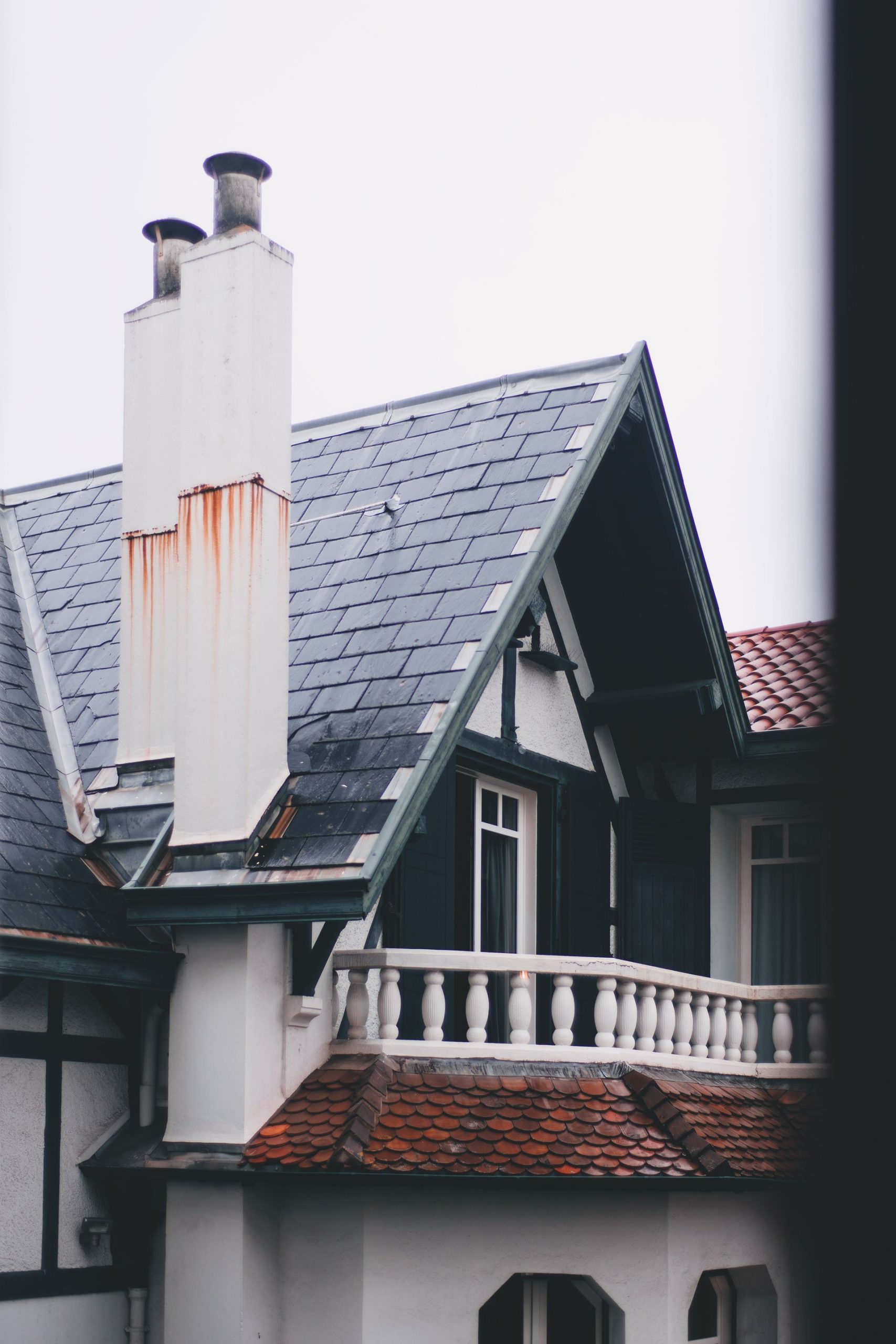 Older house facade with tall brick chimneys